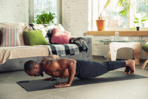 Man doing push ups in a living room.